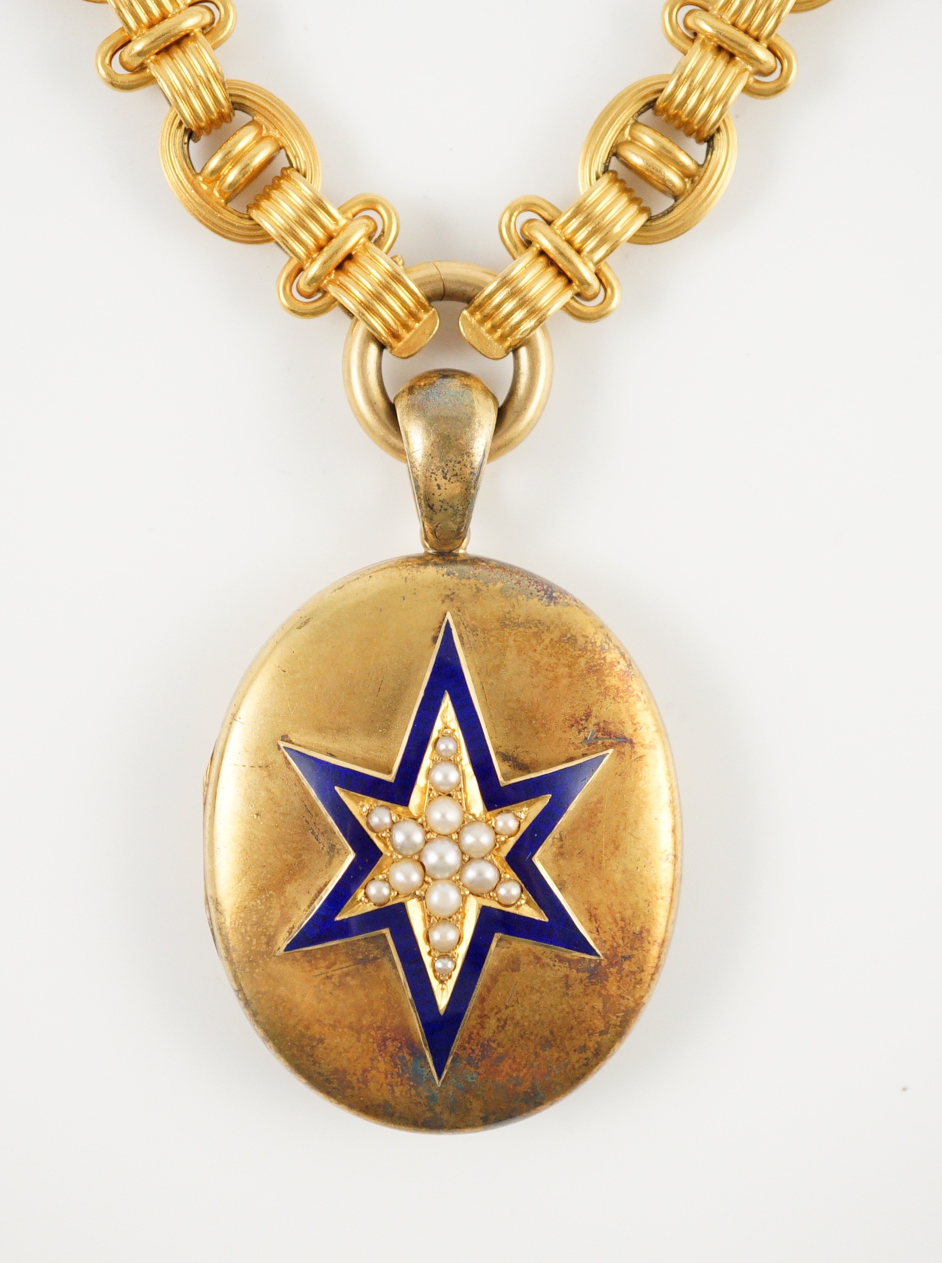 A Victorian gold, enamel and seed pearl set oval locket, on a 19th century Vienna 580/1000 gold chain